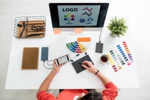 Flat layout of young web designer with stylus and graph - Big Easy SEO